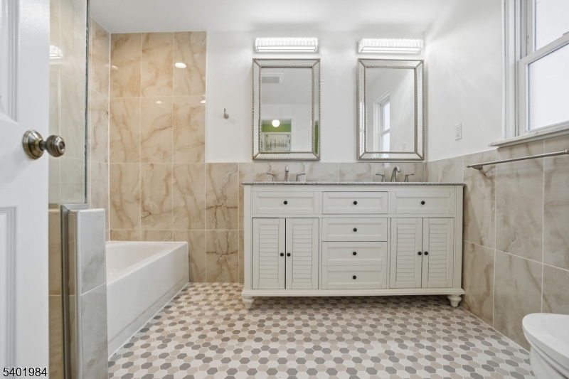 95 Martin Road Livingston, NJ 07039 - Photo 8 of 26 a bathroom with a granite countertop sink a toilet a mirror and shower