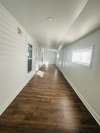 a view of a room with wooden floor