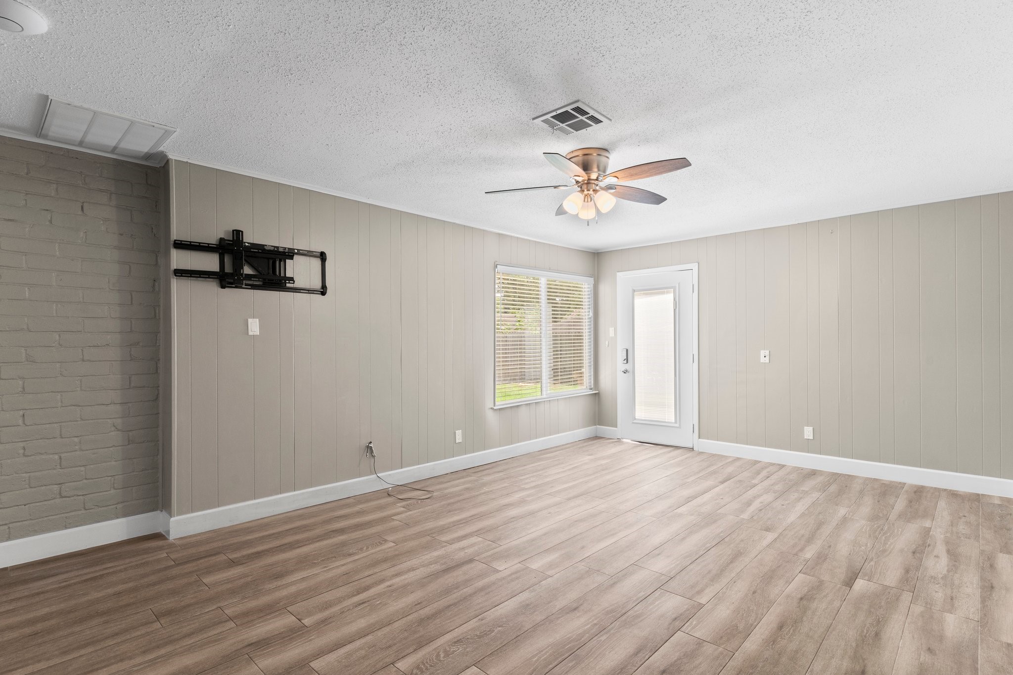 27234 Wells Lane Conroe, TX 77385 - Photo 6 of 15 a view of an empty room with a window and wooden floor
