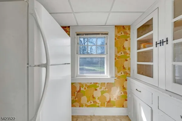 a kitchen with cabinets a window and appliances