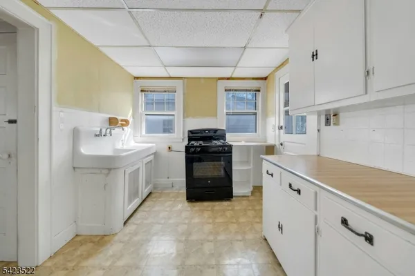 wooden floor in an empty room with a chandelier fan