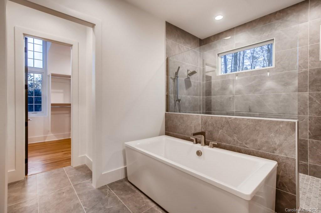 1104 Vision Path Concord, NC 28027 - Photo 16 of 28 a bathroom with a bathtub and shower