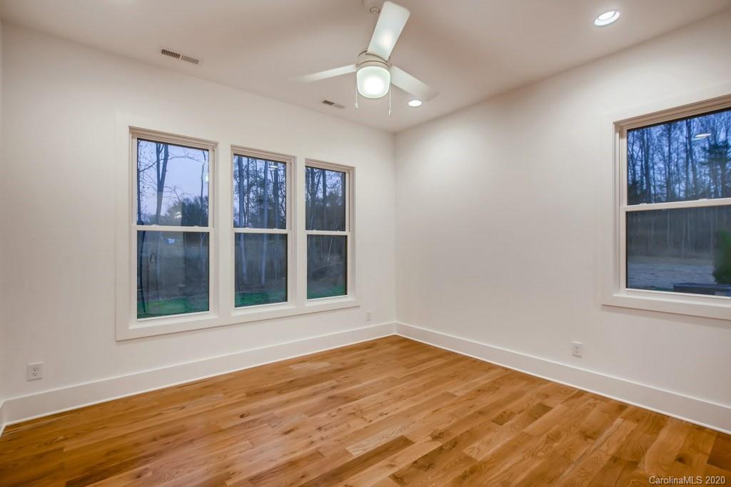 1104 Vision Path Concord, NC 28027 - Photo 17 of 28 a view of an empty room with a window and wooden floor
