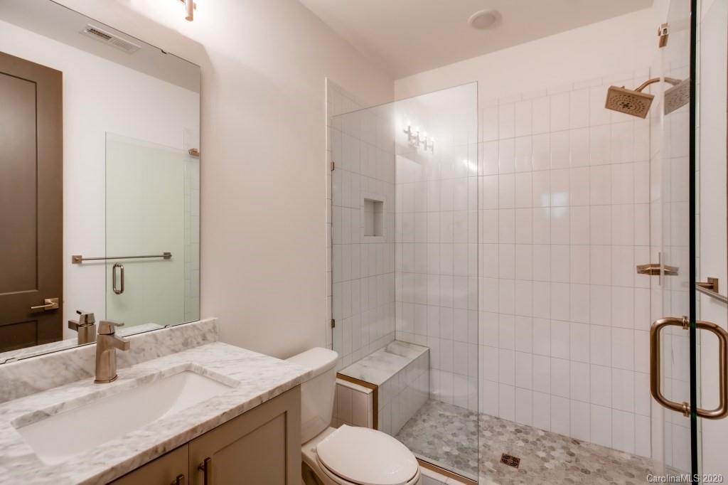 1104 Vision Path Concord, NC 28027 - Photo 18 of 28 a bathroom with a granite countertop sink toilet and shower