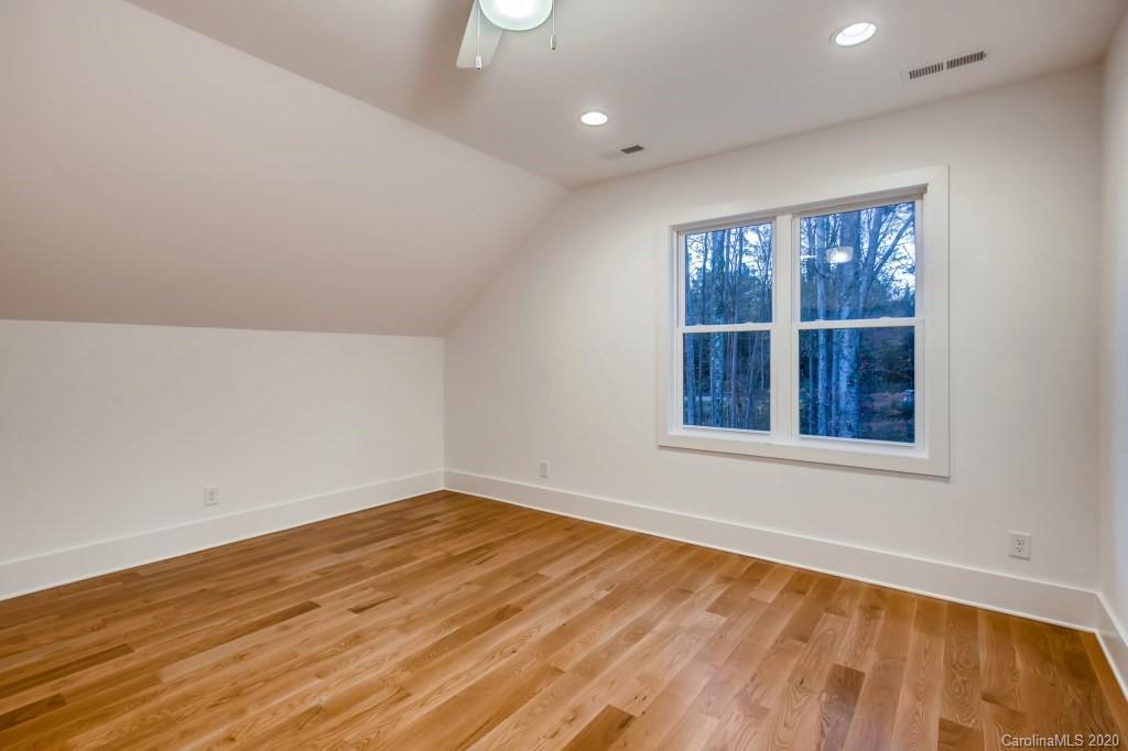 1104 Vision Path Concord, NC 28027 - Photo 19 of 28 a view of an empty room with wooden floor and windows