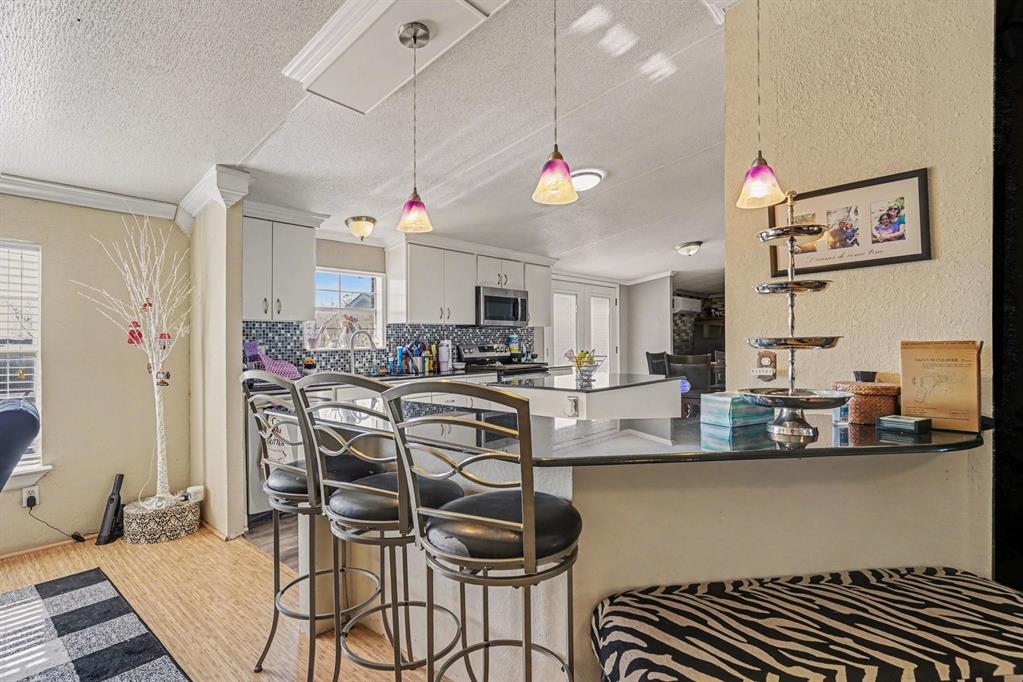 21664 Highway 34 Terrell, TX 75161 - Photo 11 of 34 a kitchen with stainless steel appliances kitchen island granite countertop a table and chairs in it