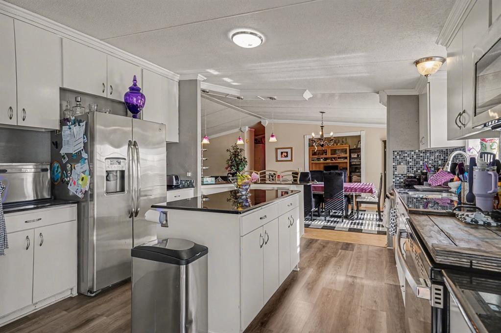 21664 Highway 34 Terrell, TX 75161 - Photo 12 of 34 a kitchen with granite countertop a sink stove and cabinets
