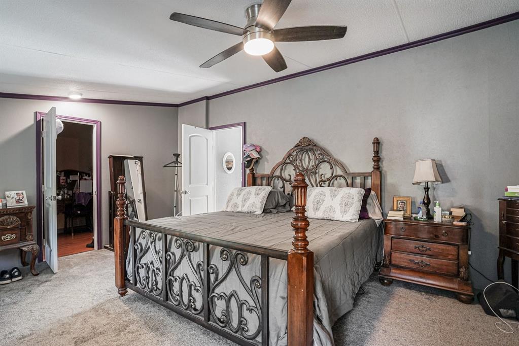 21664 Highway 34 Terrell, TX 75161 - Photo 20 of 34 a bedroom with furniture and a chandelier