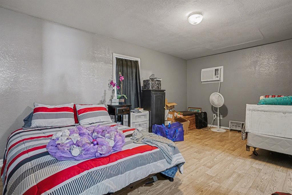 21664 Highway 34 Terrell, TX 75161 - Photo 23 of 34 a bedroom with a bed and a chandelier