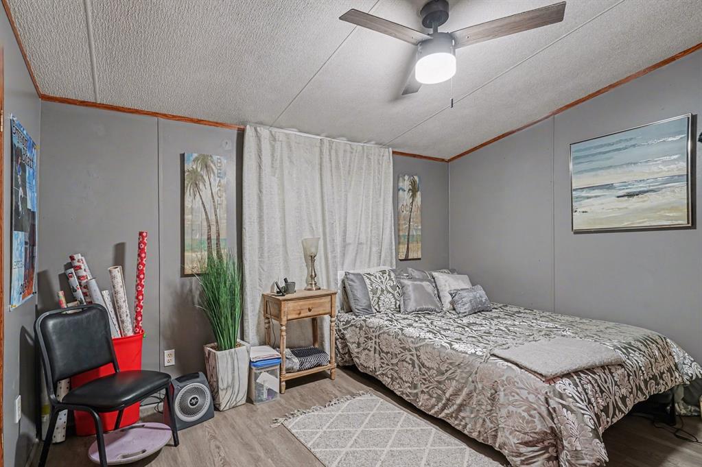 21664 Highway 34 Terrell, TX 75161 - Photo 25 of 34 a bedroom with a bed and a chandelier