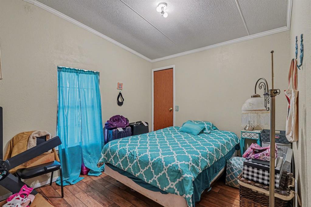 21664 Highway 34 Terrell, TX 75161 - Photo 26 of 34 a bedroom with a bed and wooden floor