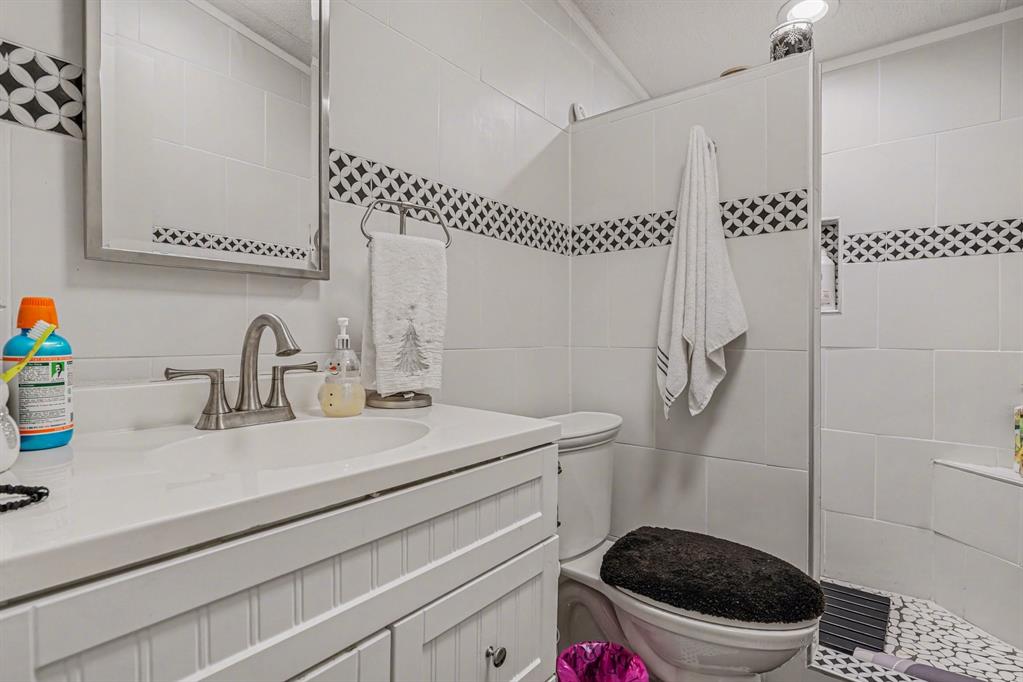 21664 Highway 34 Terrell, TX 75161 - Photo 27 of 34 a bathroom with a sink a toilet and a mirror