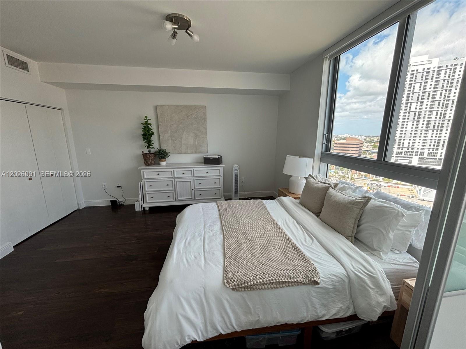 90 Southwest 3rd Street, Unit 1705 Miami, FL 33130 - Photo 9 of 33 a bedroom with a bed and wooden floor