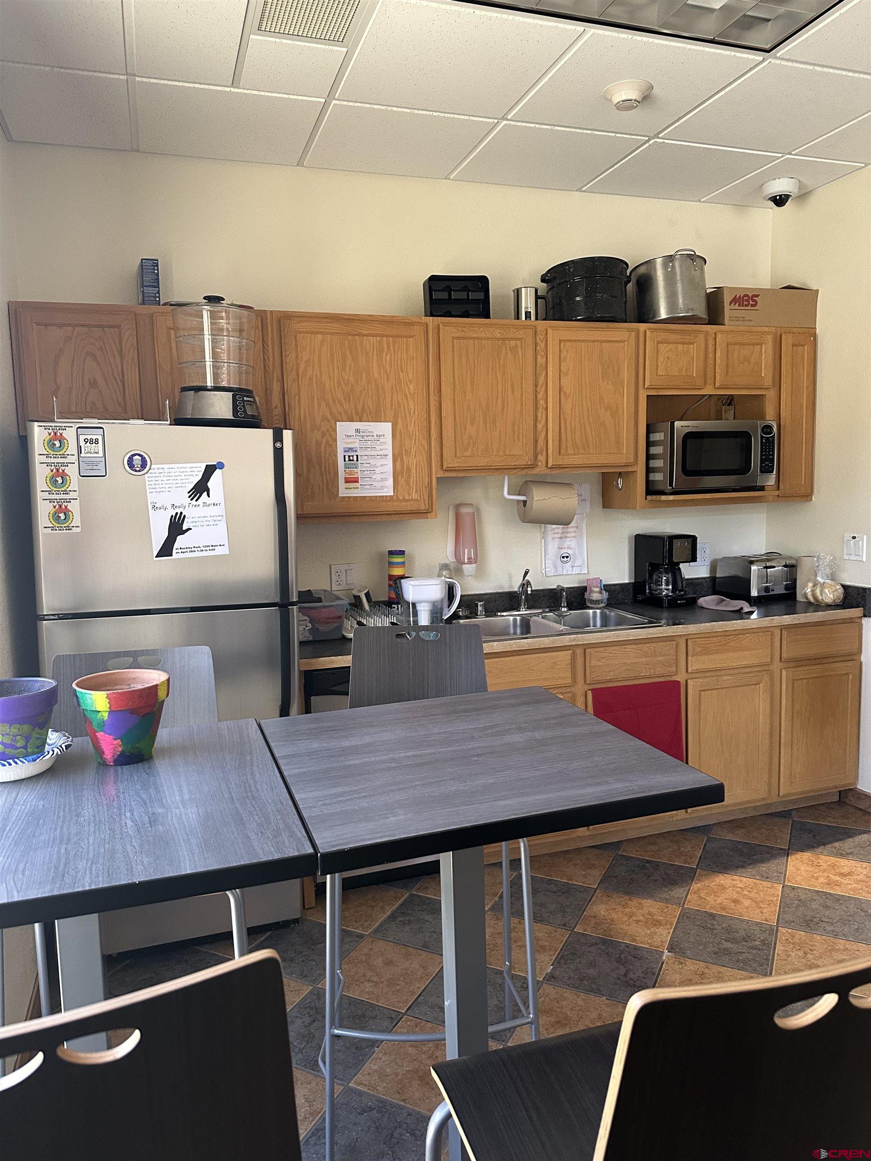 150 Tech Center Drive, Unit E Durango, CO 81301 - Photo 8 of 10 a kitchen with stainless steel appliances cabinets and a table