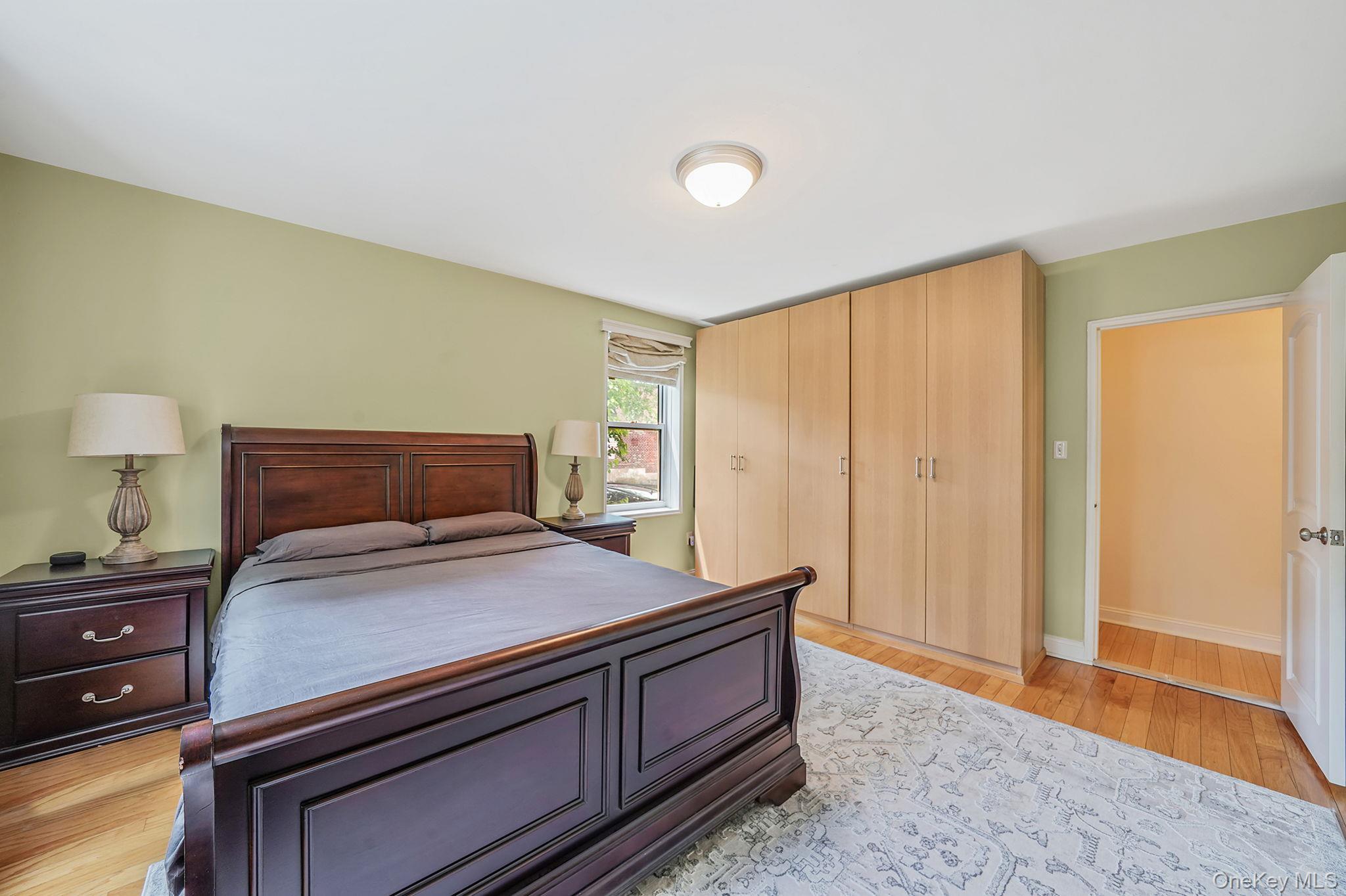 103-26 68th Avenue, Unit 2E Queens, NY 11375 - Photo 16 of 22 Bedroom with light wood finished floors, baseboards, and a closet