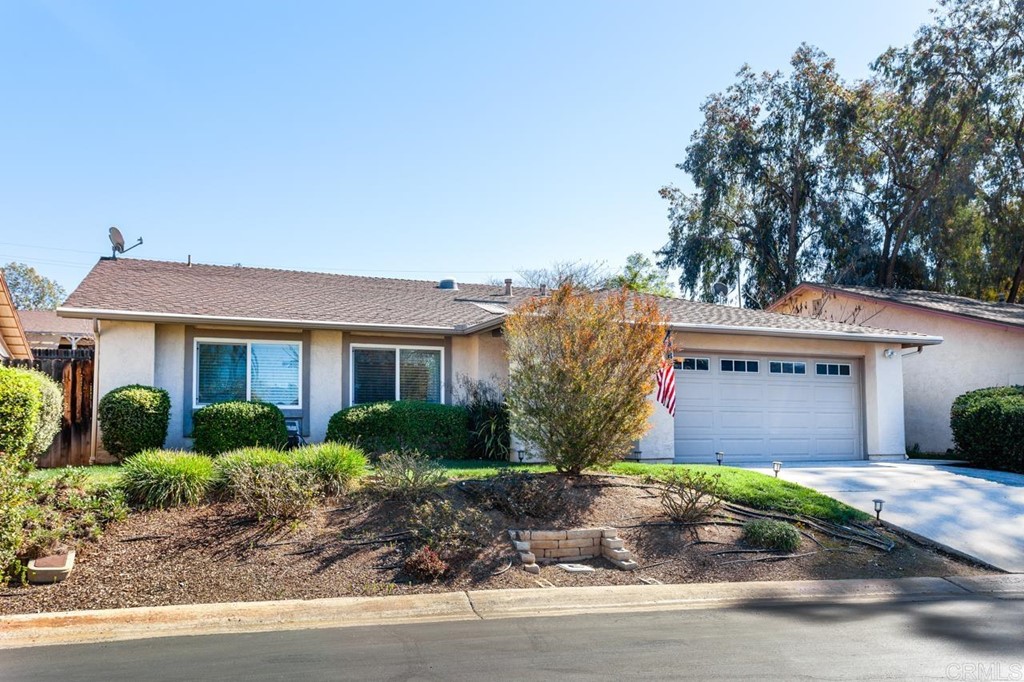927 Woodcreek Road Fallbrook, CA 92028 - Photo 1 of 1 a front view of a house with a garden and plants