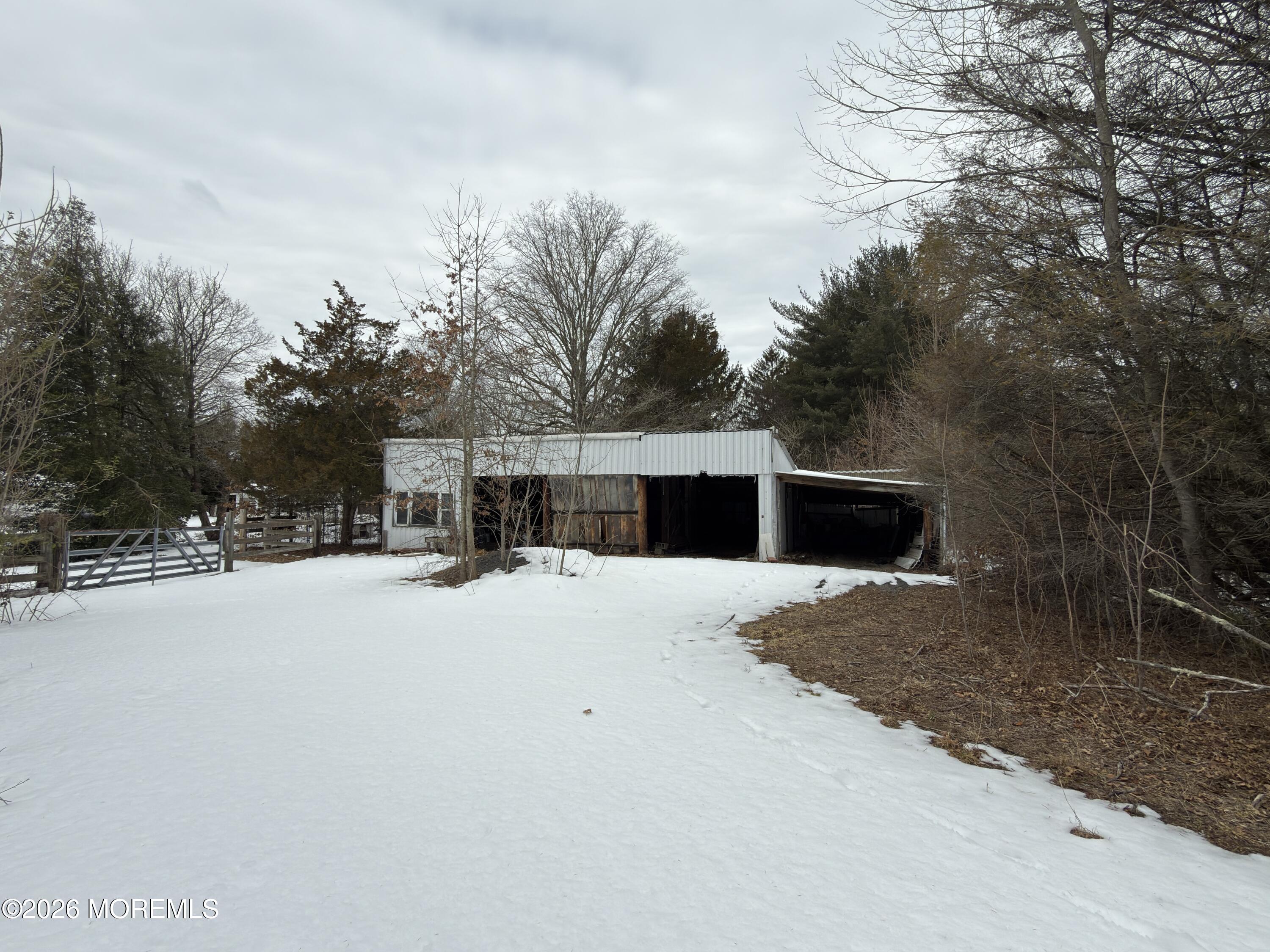 327 Sharon Road Hightstown, NJ 08520 - Photo 5 of 7 a tall yellow building with trees in front of it