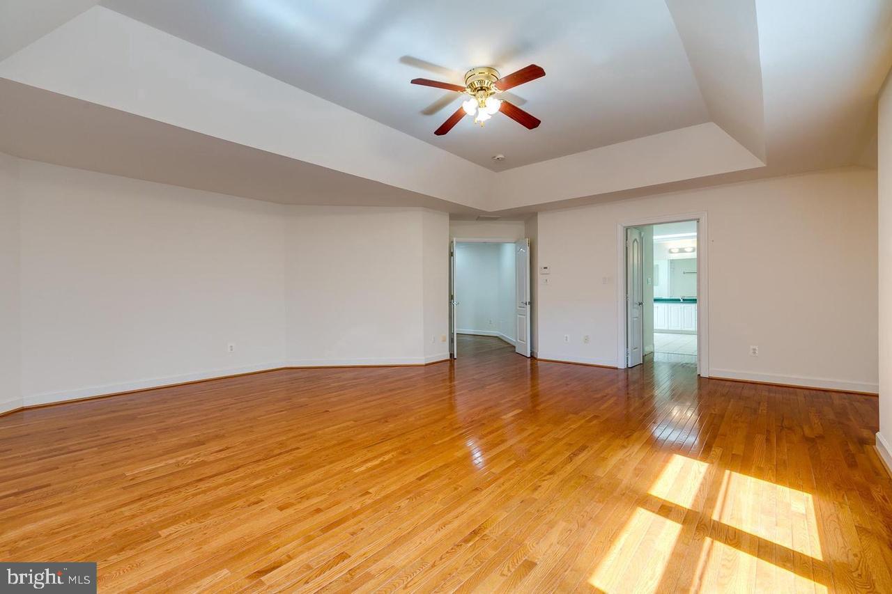 1489 Broadstone Place Vienna, VA 22182 - Photo 11 of 20 a view of an empty room with window and wooden floor
