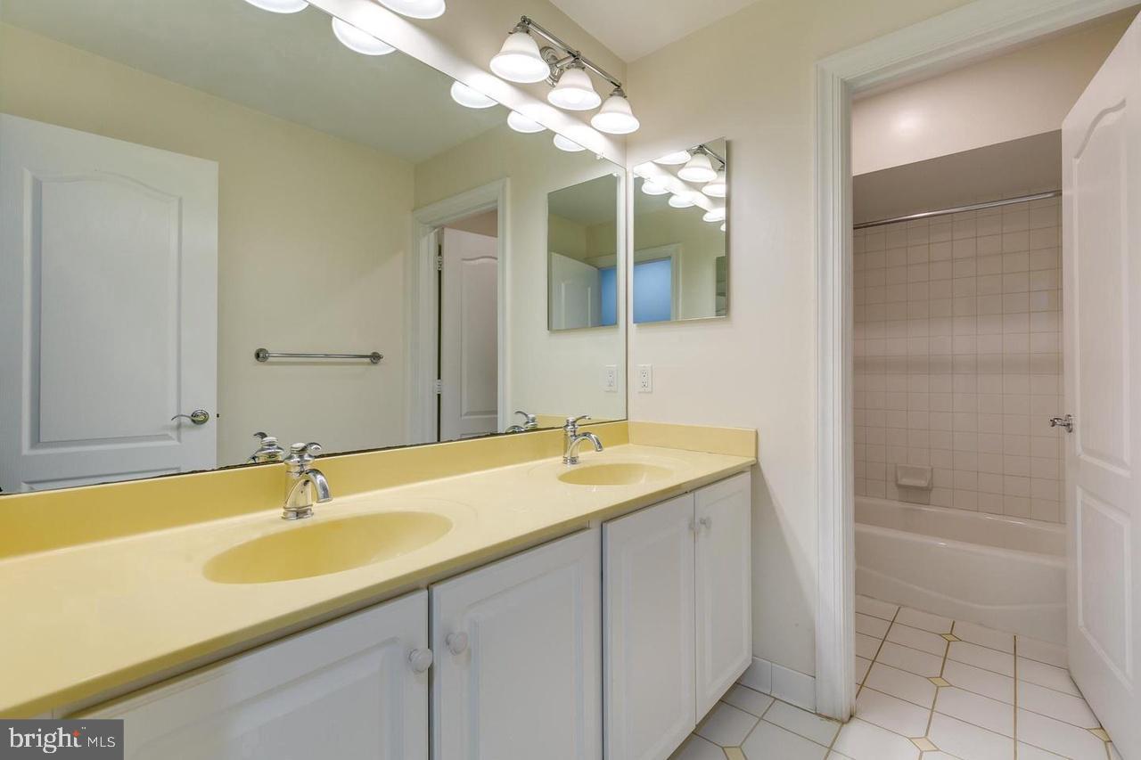 1489 Broadstone Place Vienna, VA 22182 - Photo 15 of 20 a bathroom with a sink double vanity granite tub and shower