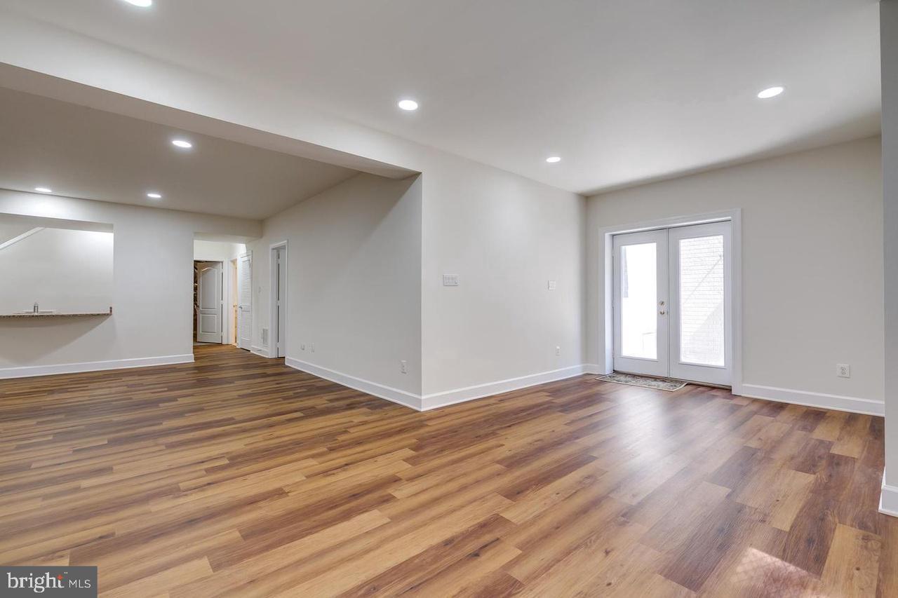 1489 Broadstone Place Vienna, VA 22182 - Photo 16 of 20 a view of an empty room with wooden floor and a window