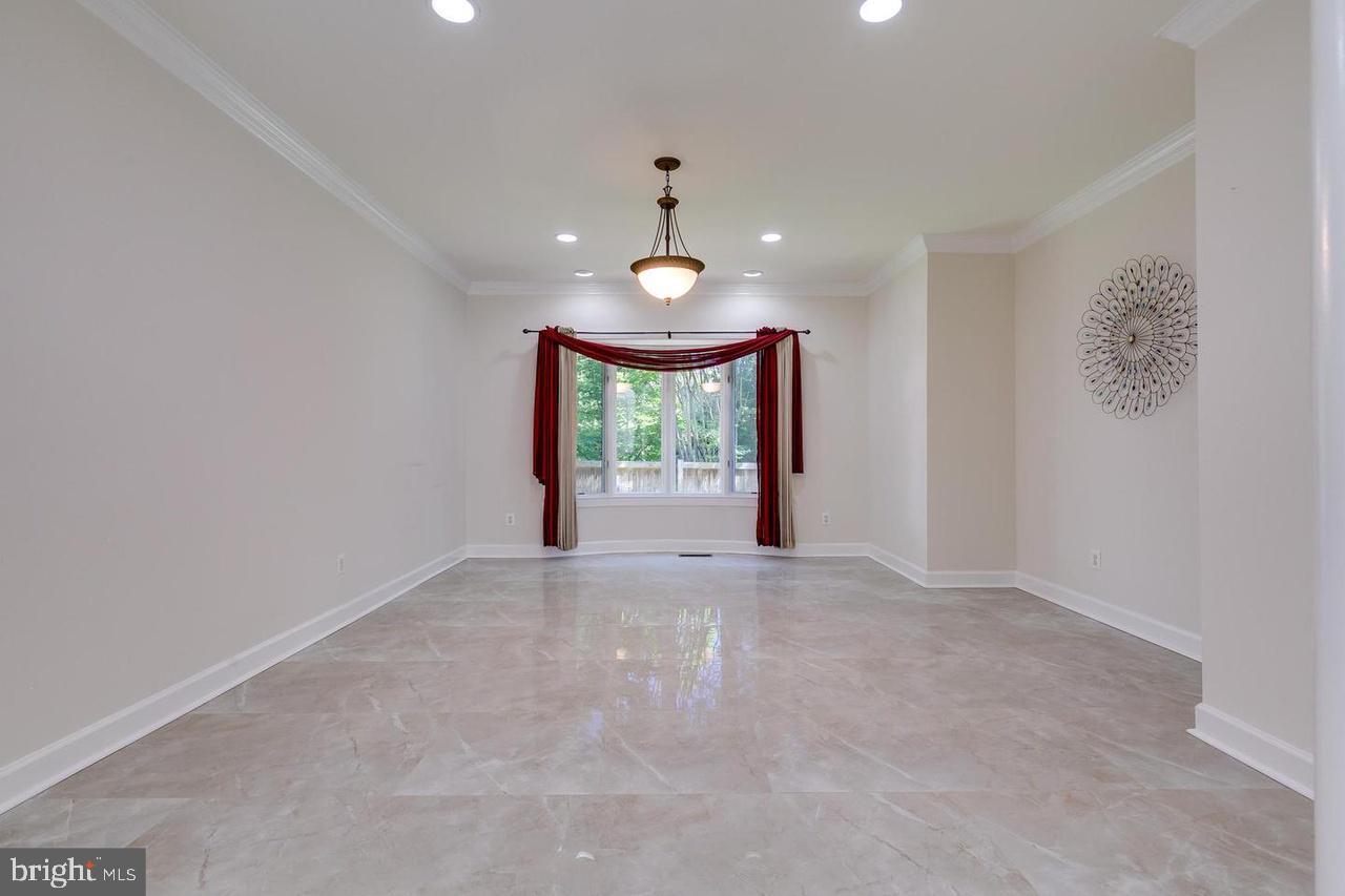 1489 Broadstone Place Vienna, VA 22182 - Photo 6 of 20 wooden floor in an empty room with a window