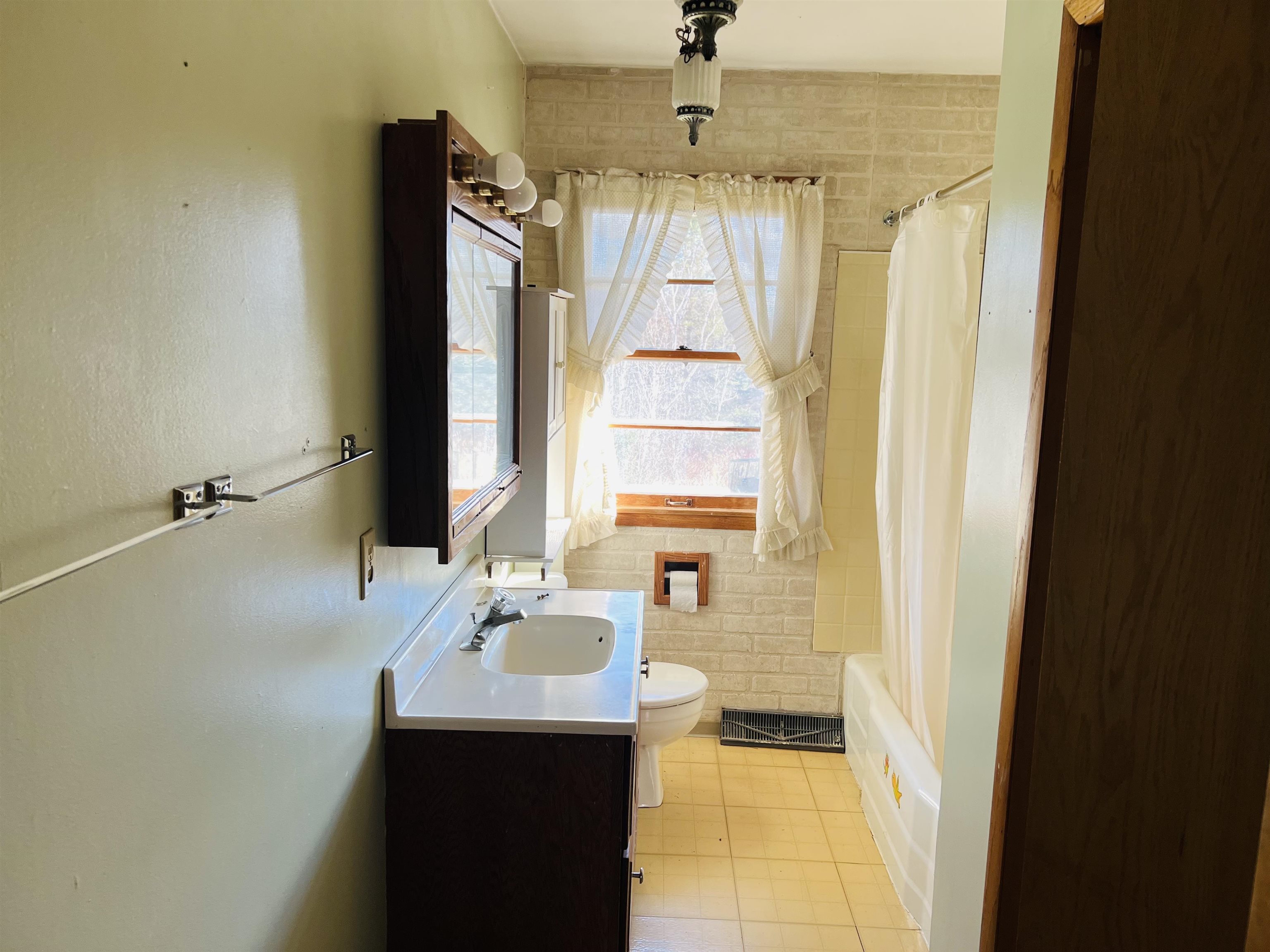 118 Rollins Ridge Tofte, MN 55615 - Photo 11 of 18 Full bathroom featuring vanity, light tile patterned floors, shower / bath combination with curtain, and tile walls