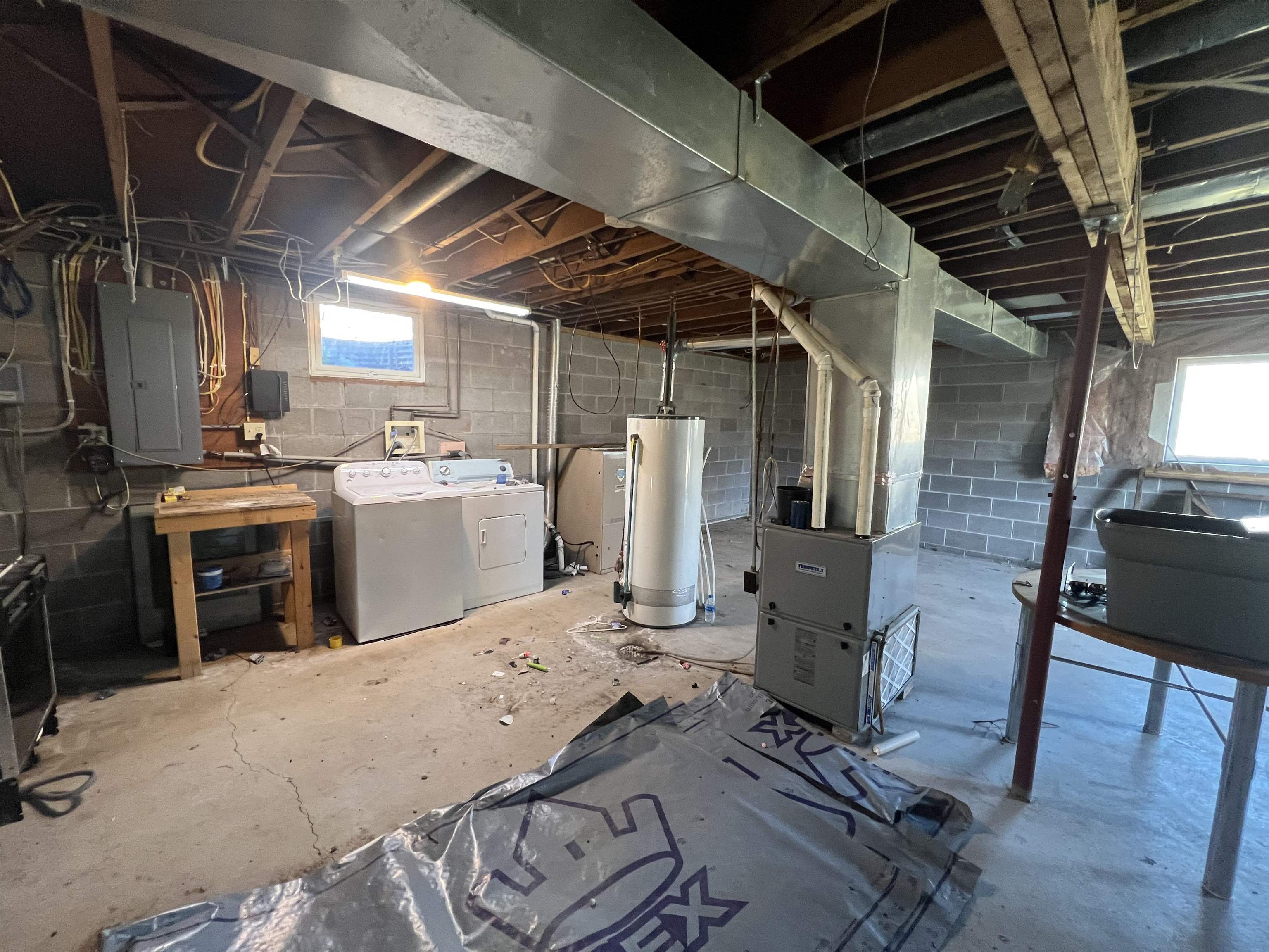 118 Rollins Ridge Tofte, MN 55615 - Photo 15 of 18 Basement featuring independent washer and dryer, electric panel, water heater, and heating unit
