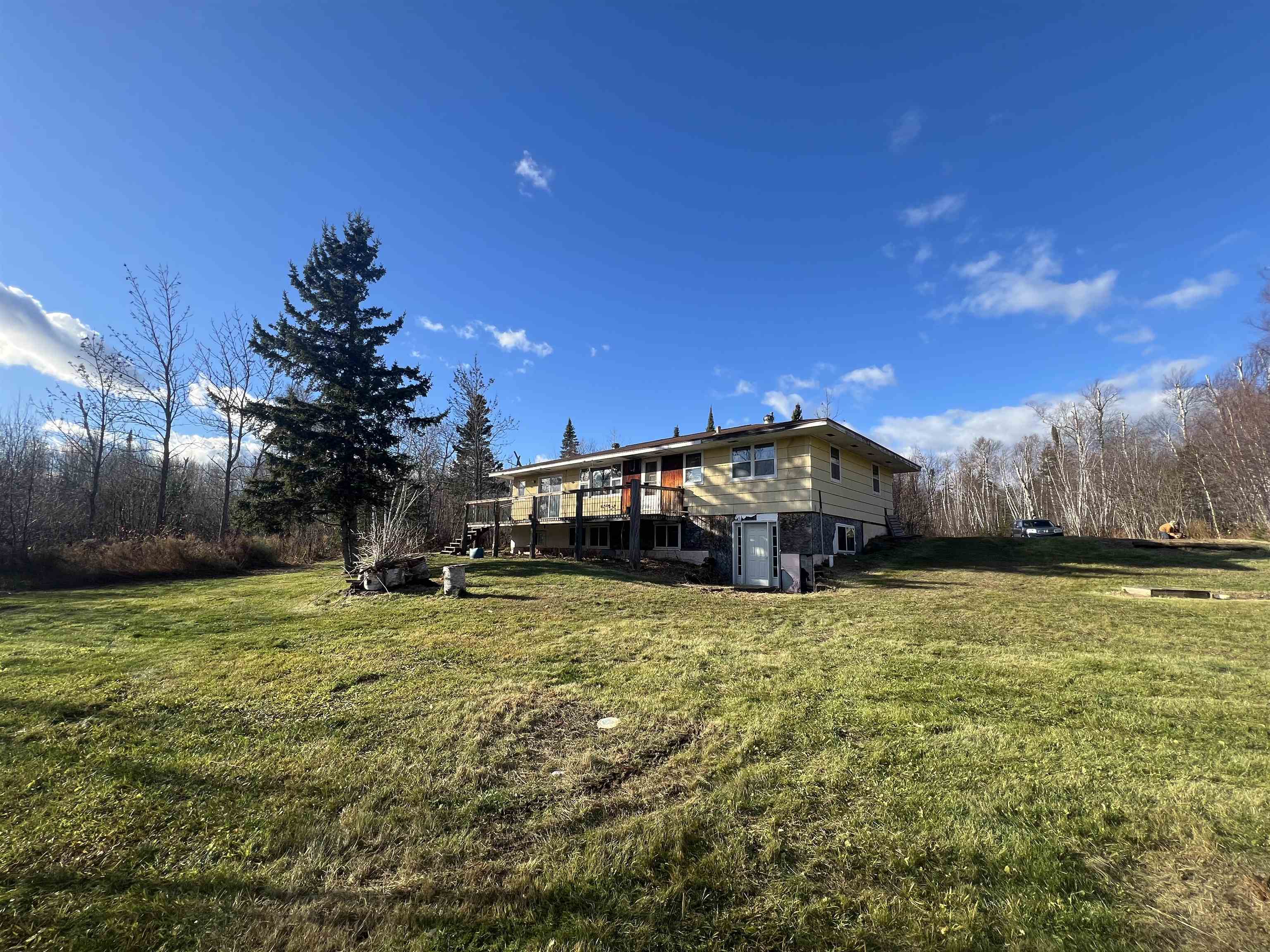 118 Rollins Ridge Tofte, MN 55615 - Photo 6 of 18 Rear view of property featuring a lawn