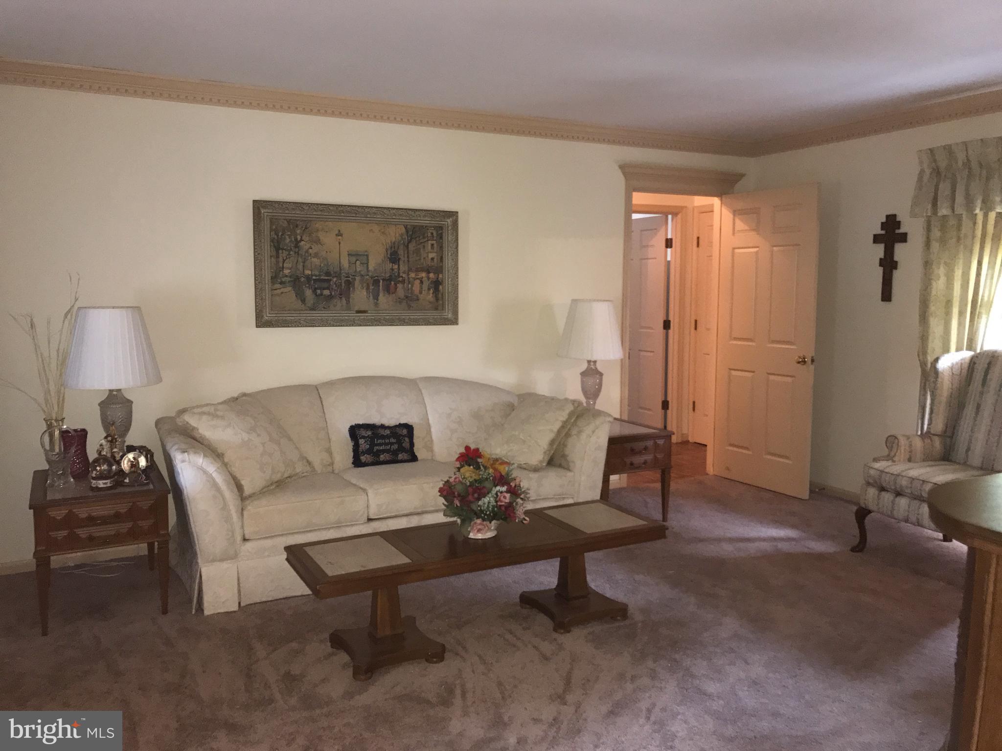 3121 Carroll Road Huntingtown, MD 20639 - Photo 2 of 26 a living room with furniture and a lamp