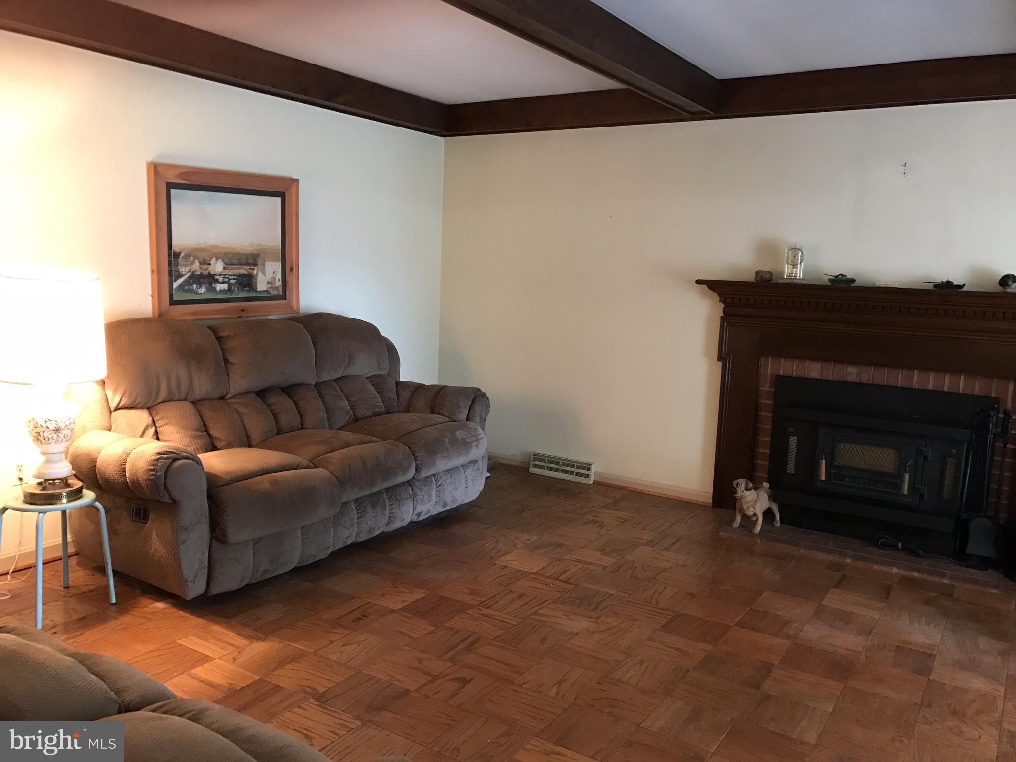 3121 Carroll Road Huntingtown, MD 20639 - Photo 13 of 26 a living room with furniture and a fireplace