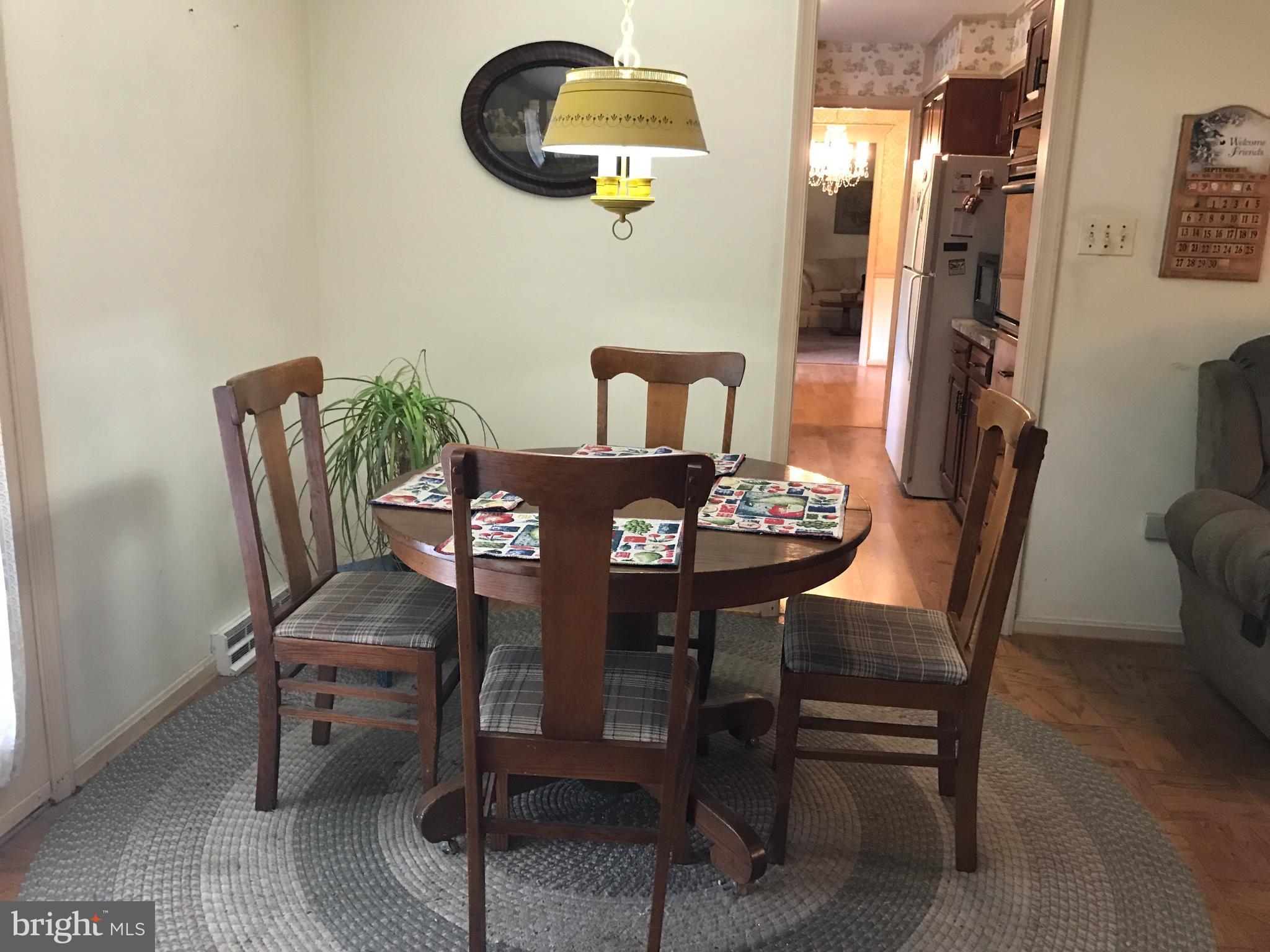 3121 Carroll Road Huntingtown, MD 20639 - Photo 14 of 26 a view of a dining room with furniture and chandelier