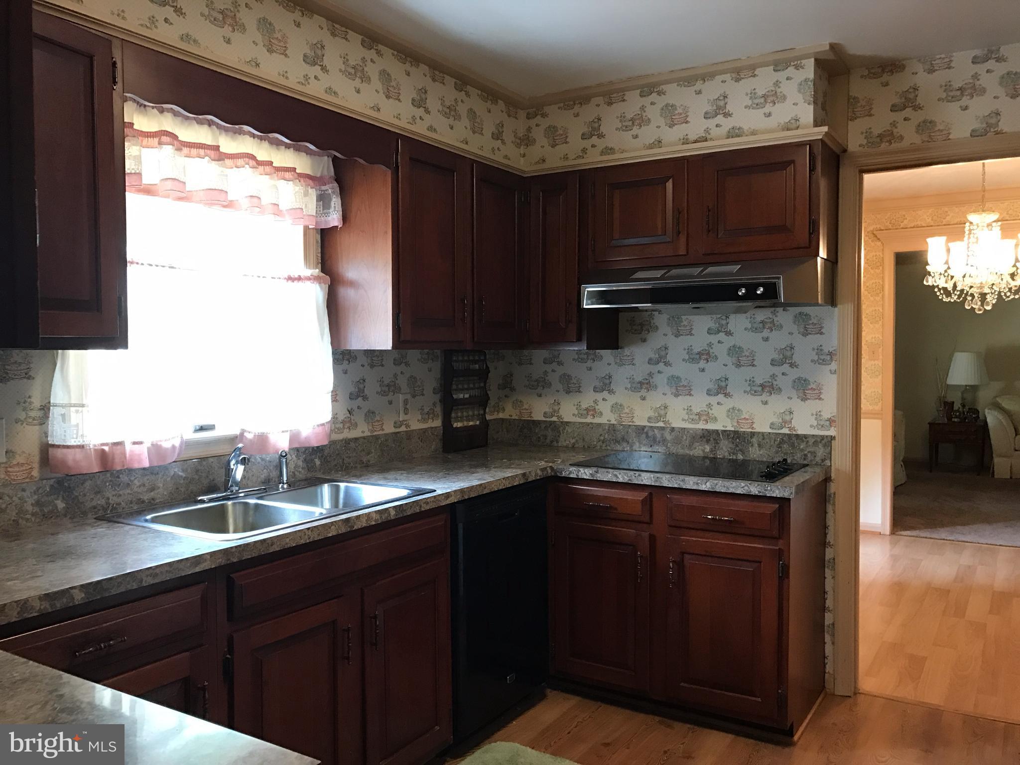 3121 Carroll Road Huntingtown, MD 20639 - Photo 15 of 26 a kitchen with stainless steel appliances granite countertop wooden cabinets a sink and dishwasher