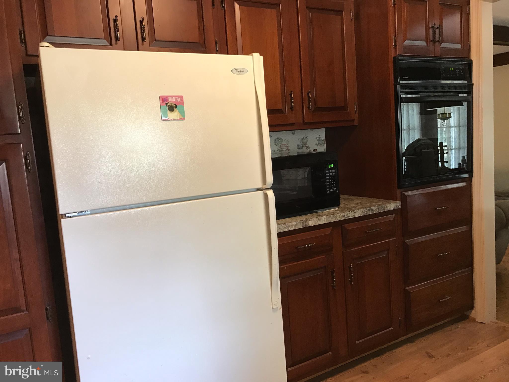 3121 Carroll Road Huntingtown, MD 20639 - Photo 17 of 26 a white refrigerator freezer sitting in a kitchen