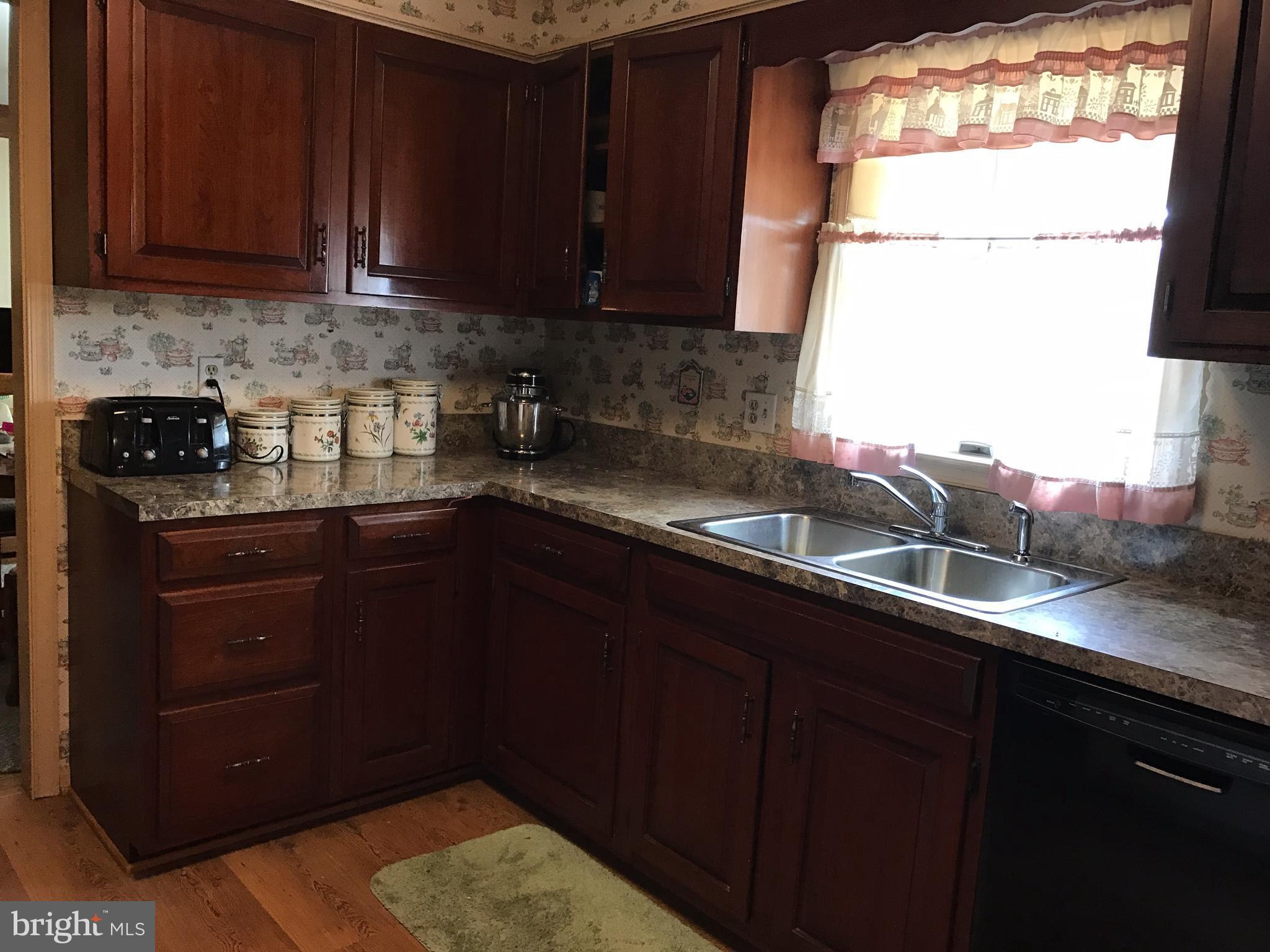 3121 Carroll Road Huntingtown, MD 20639 - Photo 18 of 26 a kitchen with granite countertop a sink a stove and cabinets