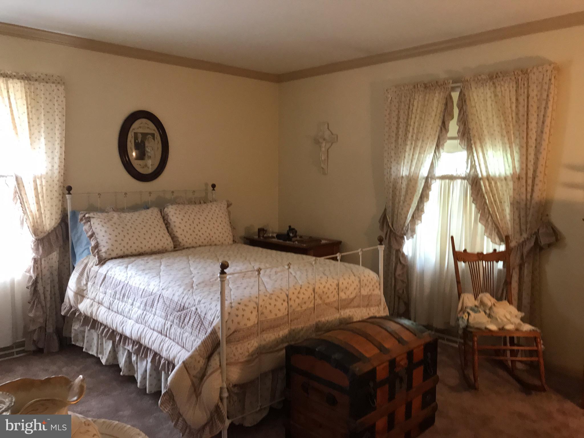 3121 Carroll Road Huntingtown, MD 20639 - Photo 19 of 26 a bedroom with a bed and a lamp on dresser