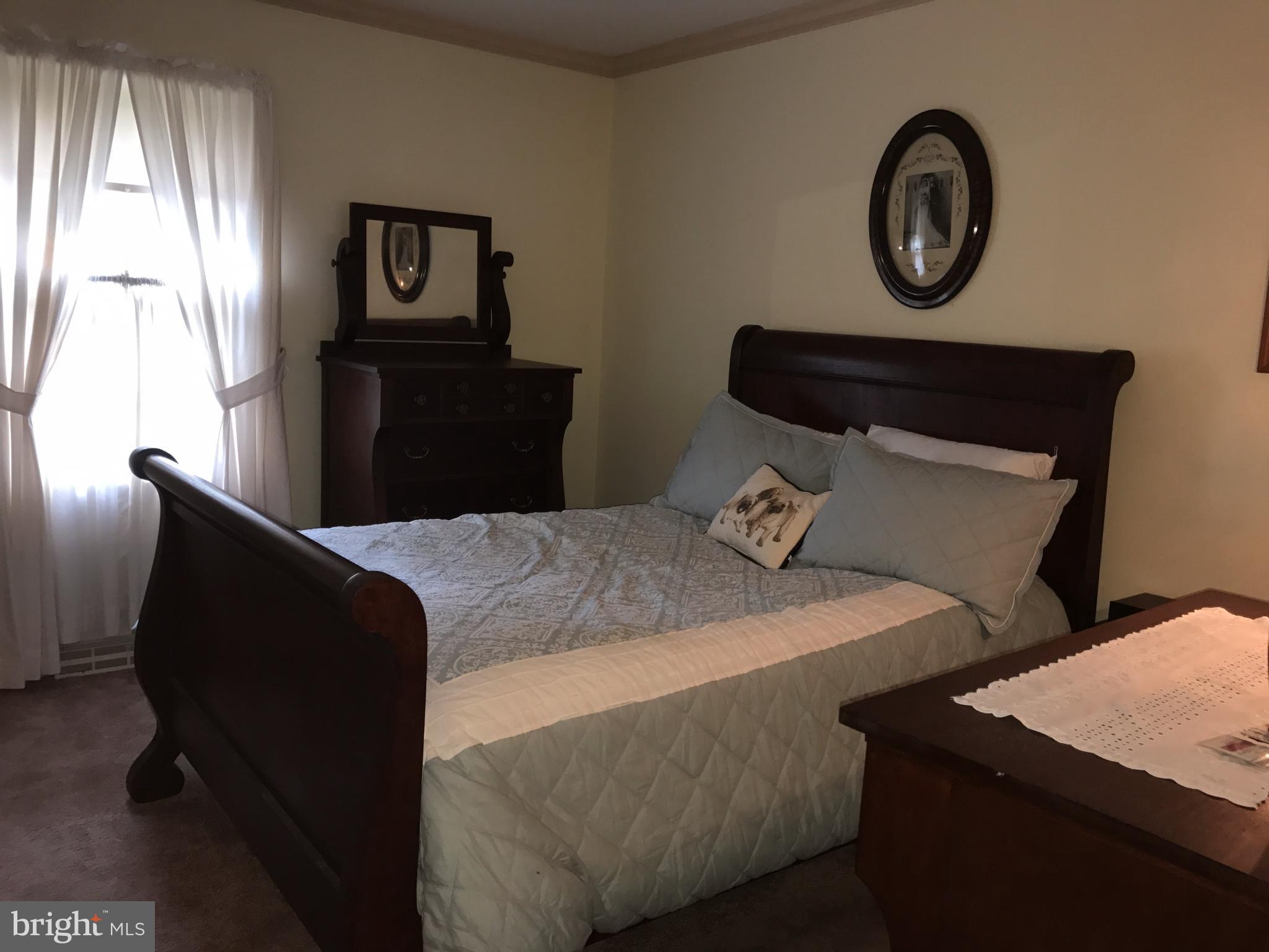 3121 Carroll Road Huntingtown, MD 20639 - Photo 21 of 26 a bedroom with a bed and a window