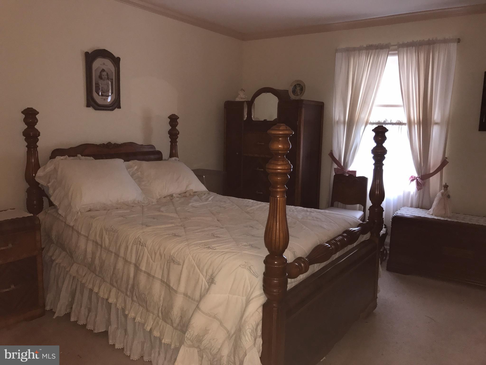 3121 Carroll Road Huntingtown, MD 20639 - Photo 22 of 26 a bedroom with bed and window