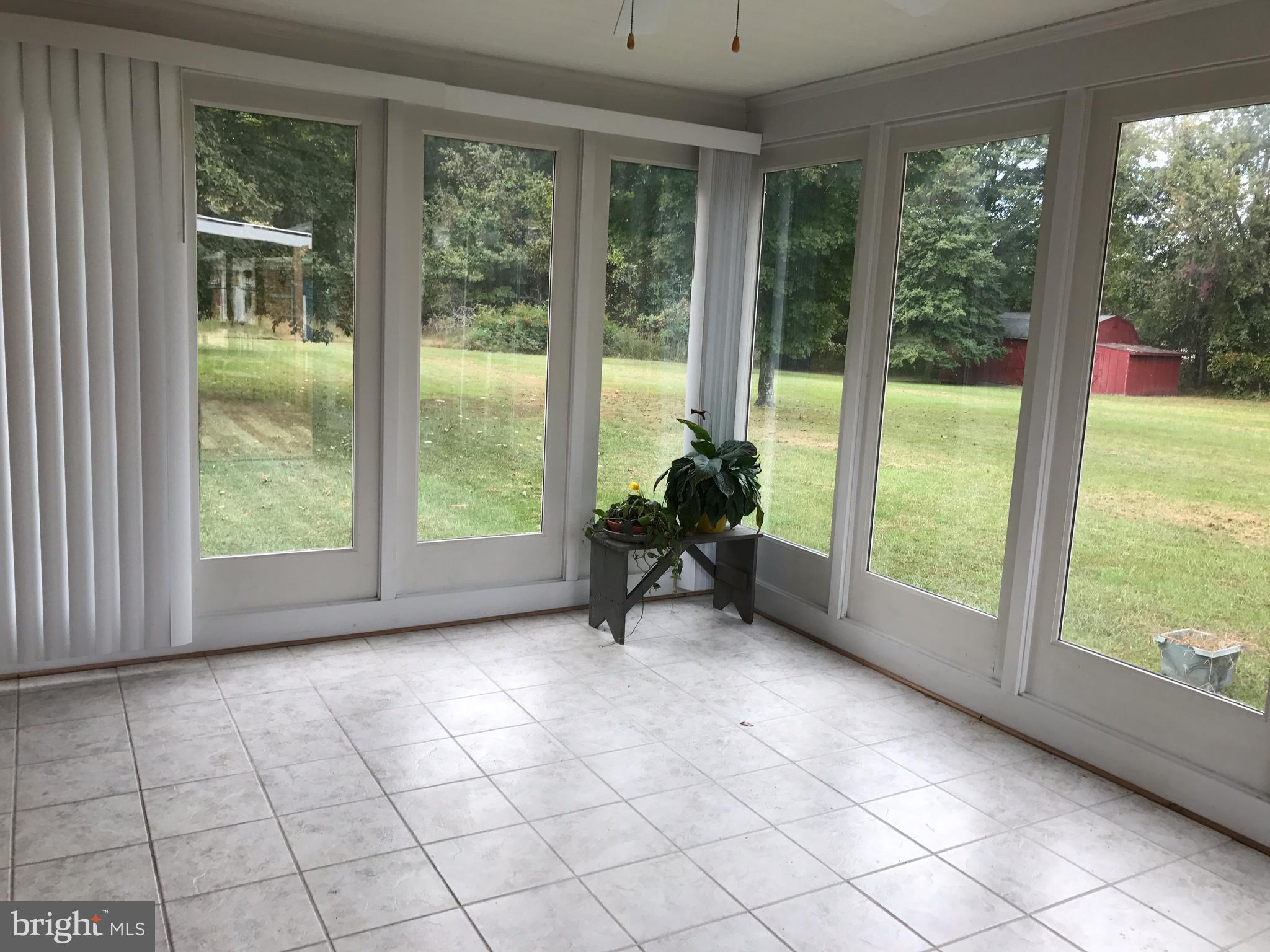 3121 Carroll Road Huntingtown, MD 20639 - Photo 4 of 26 a view of an empty room with windows and view of balcony