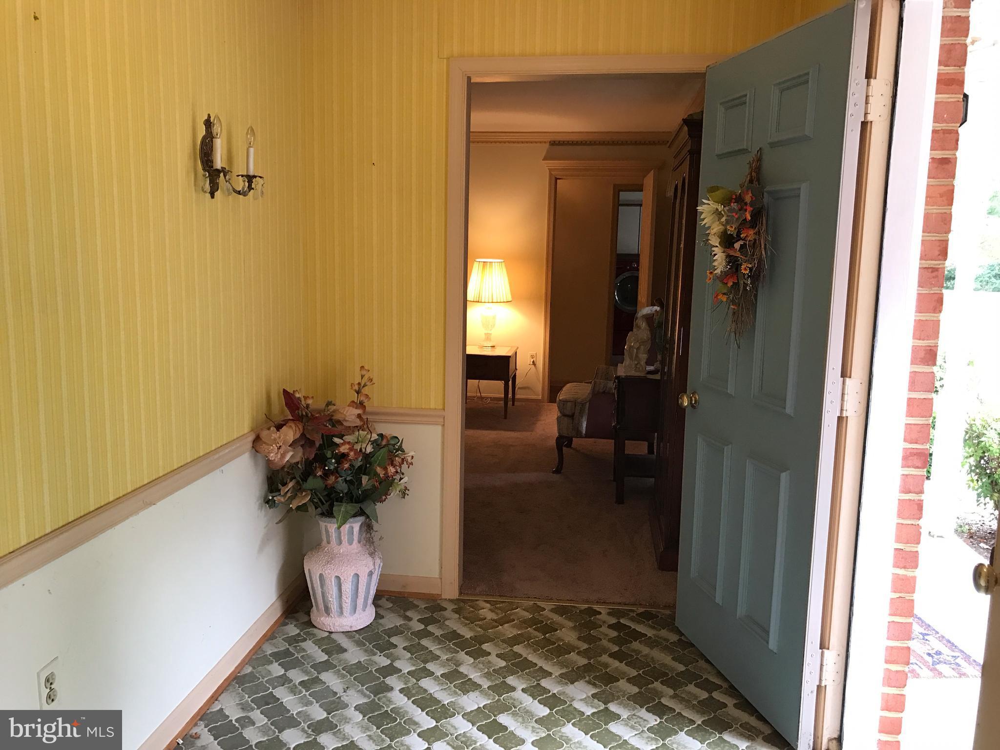 3121 Carroll Road Huntingtown, MD 20639 - Photo 8 of 26 a bath room with a chair and a potted plant
