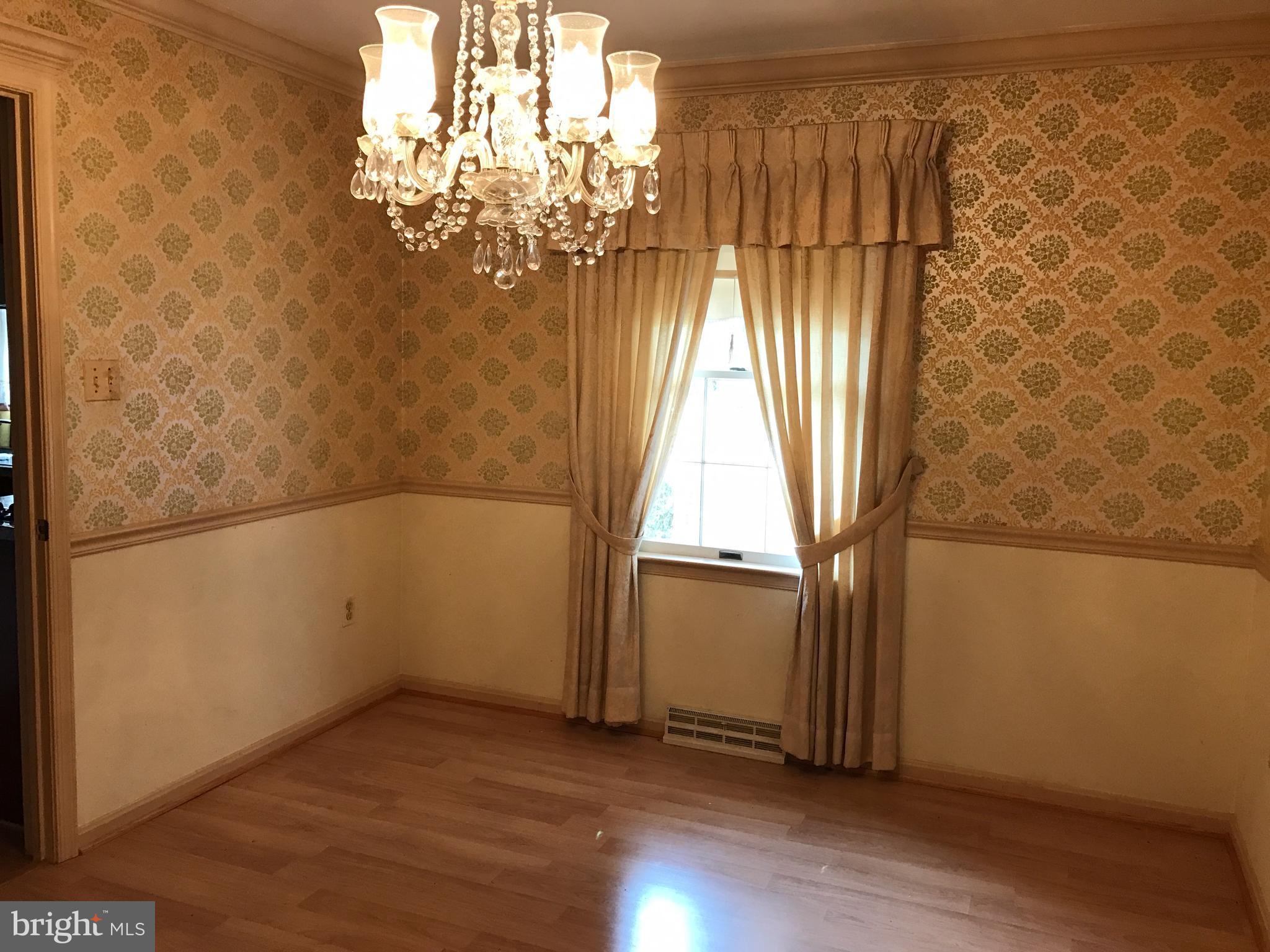 3121 Carroll Road Huntingtown, MD 20639 - Photo 10 of 26 an empty room with wooden floor and windows
