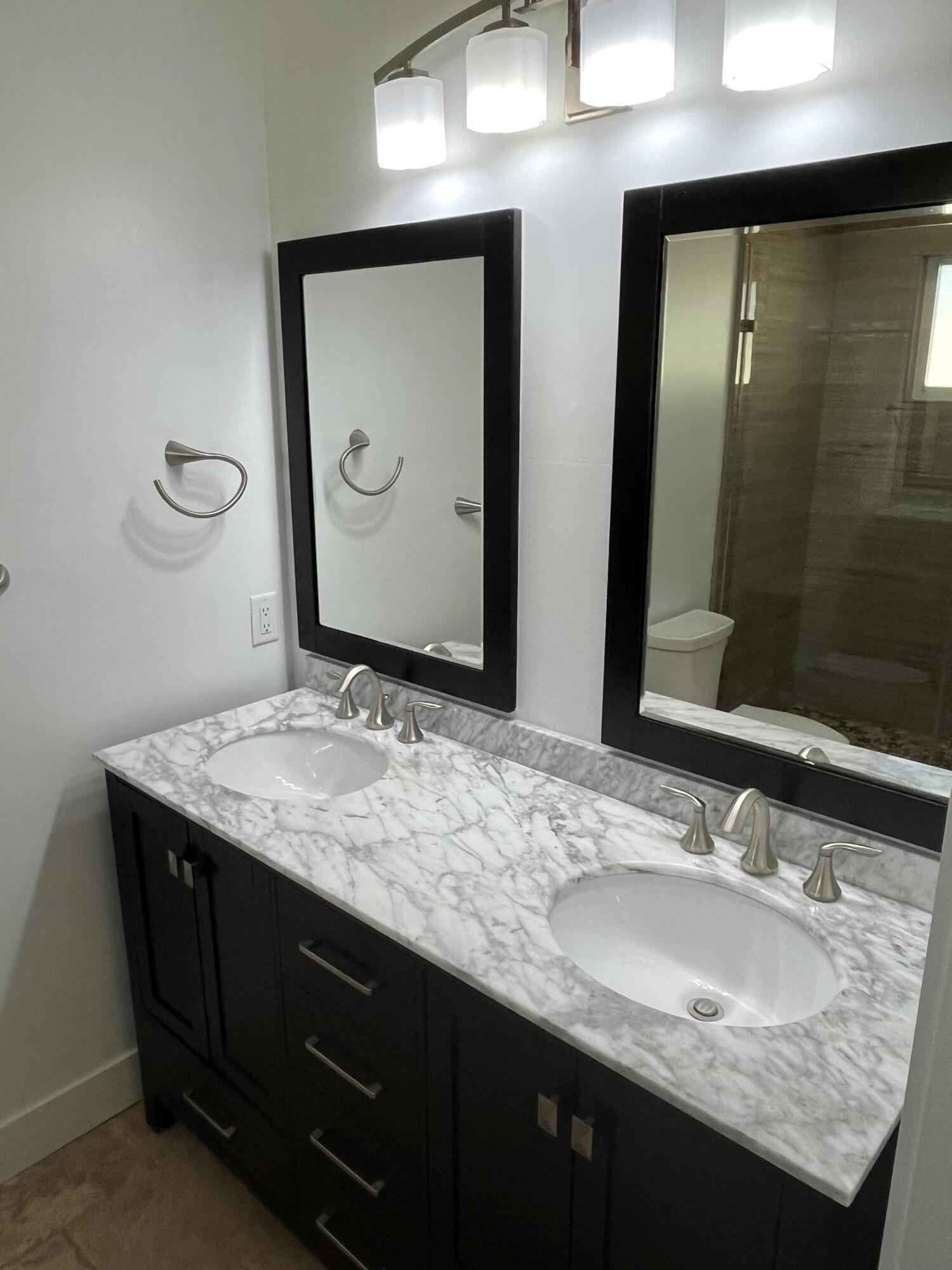 639 Cabrera Street Key Largo, FL 33037 - Photo 14 of 24 a bathroom with a granite countertop sink and a mirror