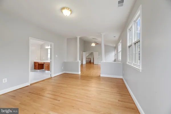 a view of an empty room with wooden floor