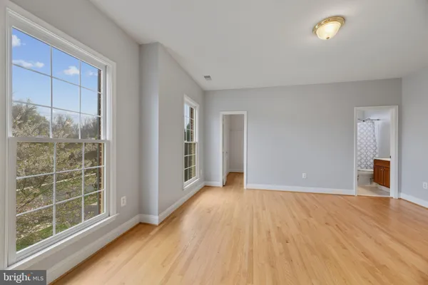a view of an empty room with wooden floor