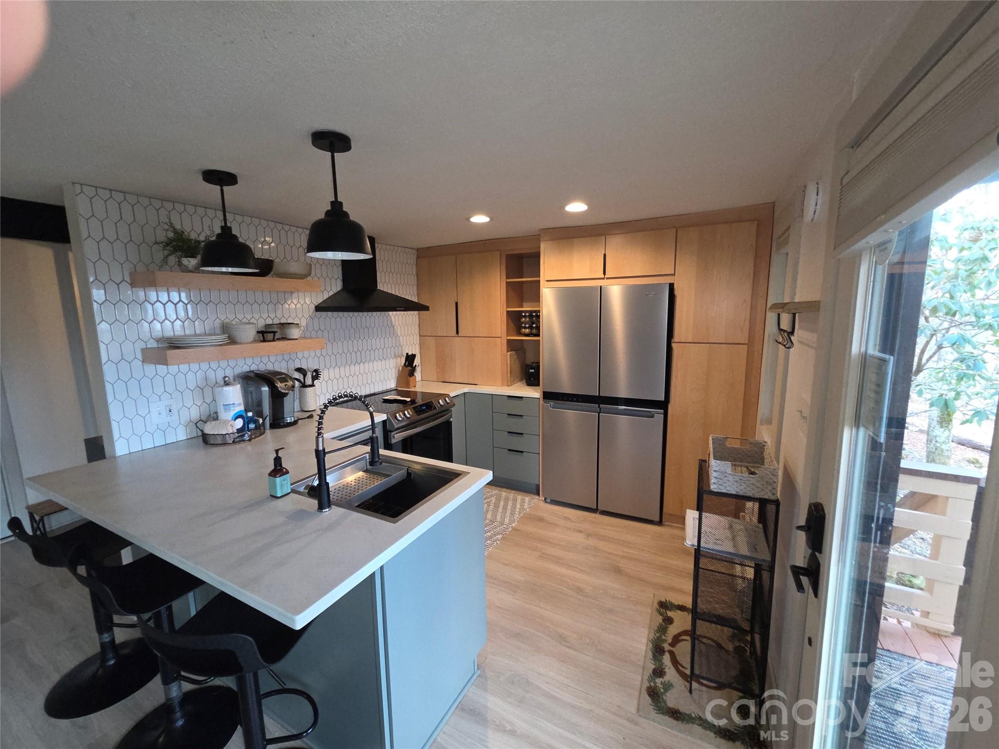 108 Northridge Road, Unit 1B Banner Elk, NC 28604 - Photo 12 of 34 a kitchen with stainless steel appliances granite countertop a refrigerator a sink dishwasher a stove and a refrigerator with wooden floor