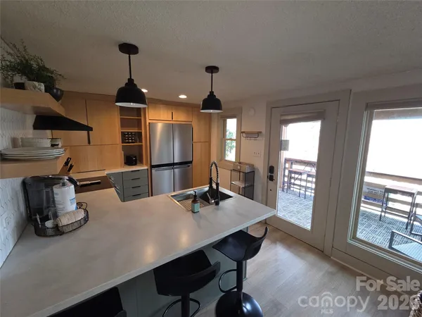 a kitchen with a table chairs and refrigerator