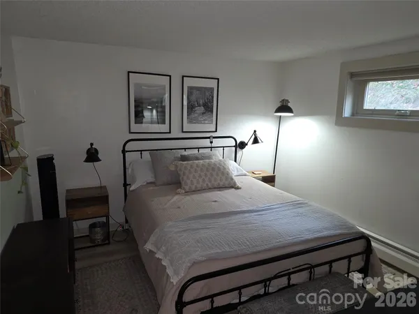 a bedroom with a bed a desk and chair