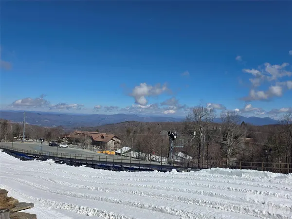 a view of a town with couple of cars parked