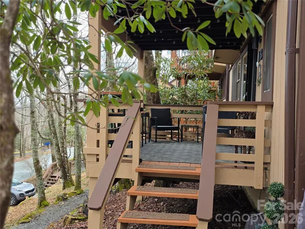 a view of balcony with wooden floor and potted plants