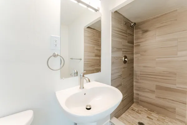a bathroom with a sink a toilet and a mirror
