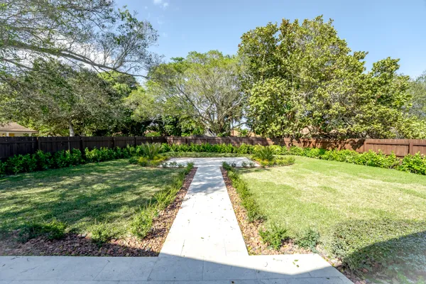 a view of yard with large trees